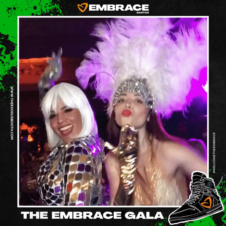 two women in costumes dancing for the photo booth